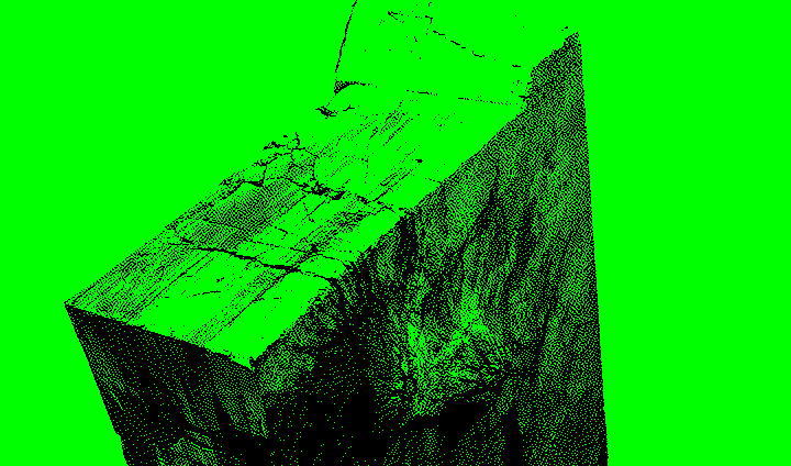 Large, cracked concrete block on a rocky beach.